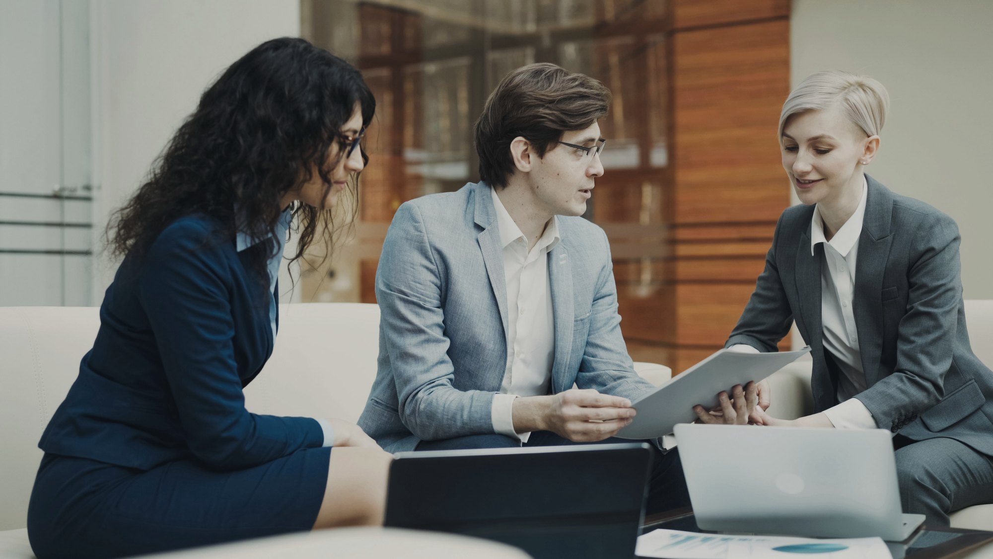 Advisor reviewing documents with two clients